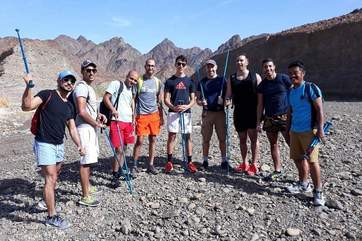 Explore Hatta's stunning landscapes while hiking and biking with friends. Experience the thrill of outdoor adventures amidst majestic mountains and scenic trails perfect for adventure enthusiasts.